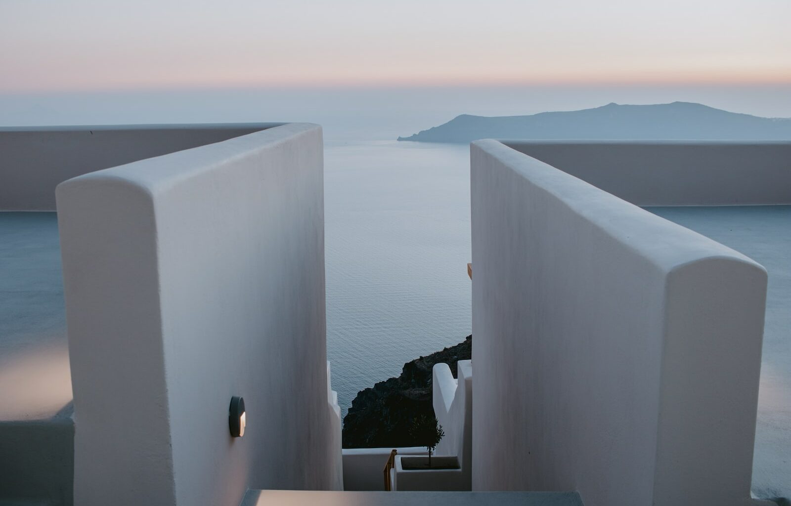 white concrete wall near body of water during daytime