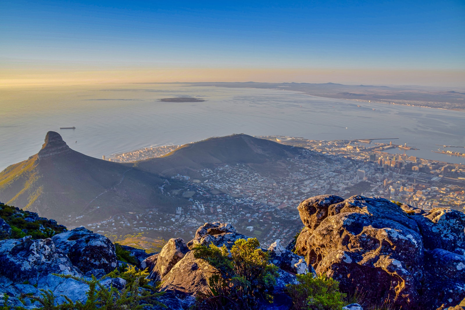 aerial view of green mountains and body of water during daytime