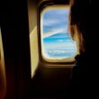 person looking outside of airplane window